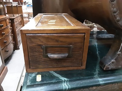 Lot 999 - Oak stationary drawer and a nest of three occasional tables