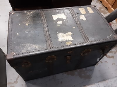 Lot 1026 - Old brass bound trunk with leather carrying handles, 96cm wide, 55cm deep, 61cm high, containing linen and wicker baskets