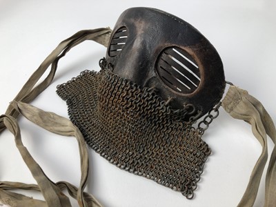 Lot 732 - Scarce First World War tank crew face mask of steel construction with leather covering, attached chain mail and cotton retaining tabs.