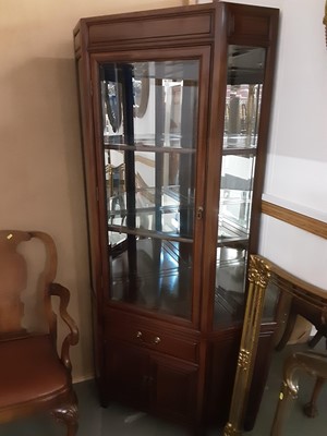 Lot 847 - Oriental hardwood two height corner cabinet with bevelled glazed door above enclosing glass shelves, single drawer and cupboards below, 90cm wide, 191cm high