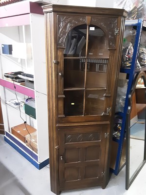 Lot 842 - Carved oak corner cupboard with arched glazed door above and panelled door below, 70cm wide, 183cm high