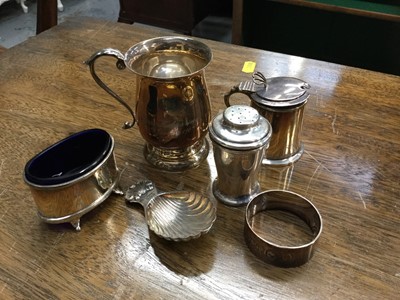 Lot 697 - Silver christening mug, silver mustard pot, silver salt cellar, silver caddy spoon, silver napkin ring and silver pepperette, All at 9.5oz