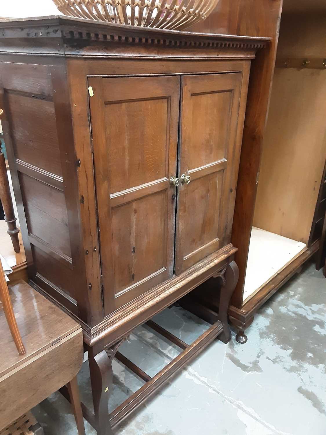 Lot 960 - Antique oak chest on stand with shelved interior enclosed by two panelled doors, 101cm wide, 50cm deep, 162.5cm high