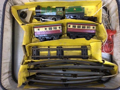 Lot 561 - Tinplate clockwork train with tender and two carriages plus track together with Triangle locomotive, carriage and two wagons, boxed, and two raincoats