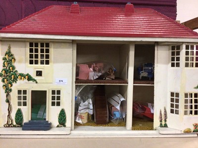 Lot 570 - Vintage metal dolls house with sliding frontage and plastic furnishings, plus miniature tea ware and dolly's house tea ware