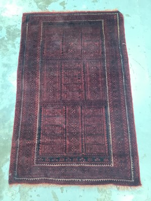 Lot 971 - Eastern rug with geometric decoration on red ground, 202cm x 125cm