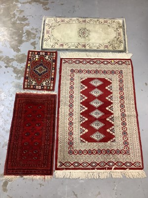 Lot 972 - Eastern rug with geometric decoration on red, blue and cream ground, 150cm x 98cm and three smaller rugs