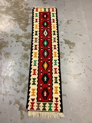 Lot 975 - Eastern runner with geometric decoration on red and cream ground, 201cm x 50cm