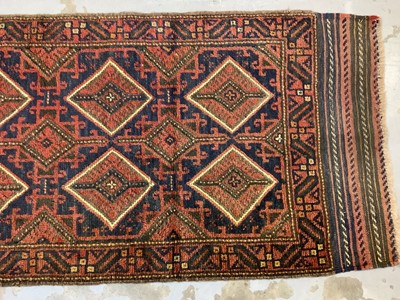 Lot 1062 - Eastern runner with geometric decoration on red and blue ground, 249cm x 78cm