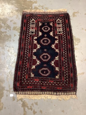 Lot 1063 - Eastern rug with geometric decoration on red ground, 143cm x 94cm