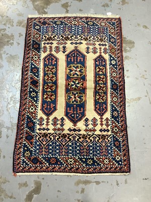 Lot 1064 - Eastern rug with geometric decoration on red, blue and cream ground, 150cm x 94cm