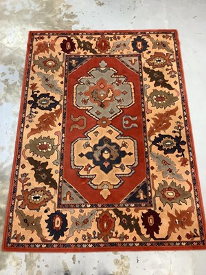 Lot 1068 - Large rug with geometric decoration on red, blue and beige ground, 326cm x 174cm