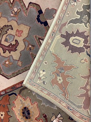 Lot 1069 - Large rug with geometric decoration on beige and green/brown ground, 299cm x 204cm