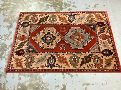 Lot 1070 - Large rug with geometric decoration on red, blue and beige ground, 201cm x 143cm