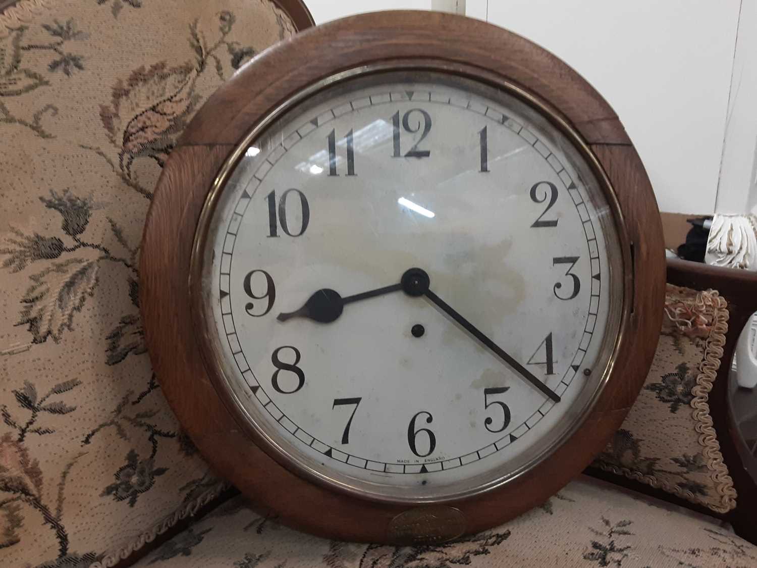 Lot 4 - Early 20th century Enfield circular wall clock in oak case, dial is 30cm diameter,  bearing label - The Property Of The St James And Pall Mall Electric Light Co Limited