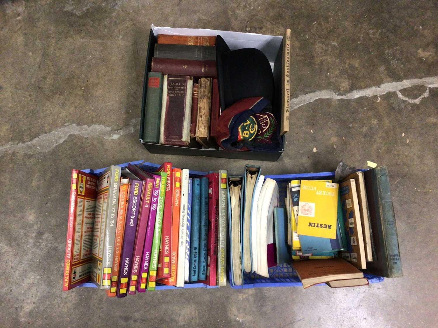Lot 117 - Three boxes of sundries, including car manuals, vintage bowler hat, badges, German language books