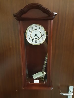 Lot 473 - Contemporary wall clock, with circular dial, complete with key and pendulum