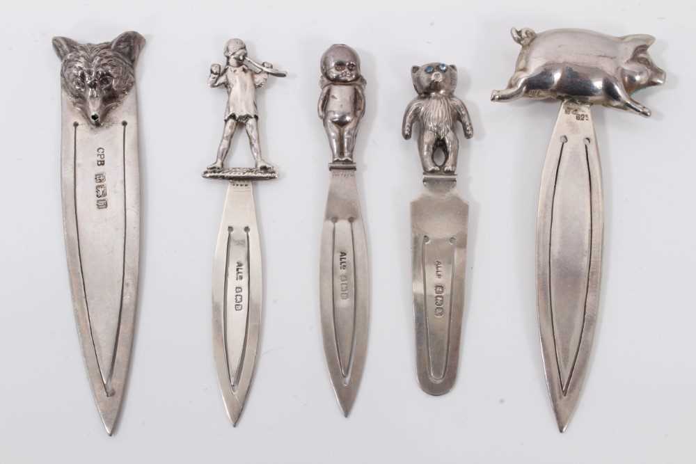 Lot 29 - Five silver bookmarks each mounted with a pig, wolf head, bear, baby and pied piper