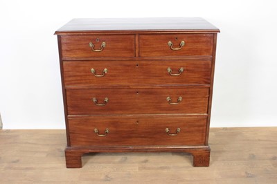 Lot 1346 - George III mahogany chest of two short and three long graduated drawers