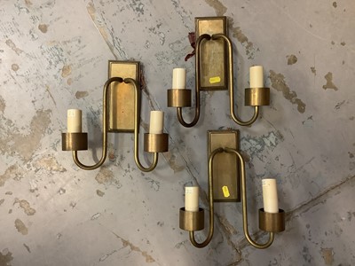 Lot 490 - Jim Lawrence double morston wall lights in antiqued brass with glass shades