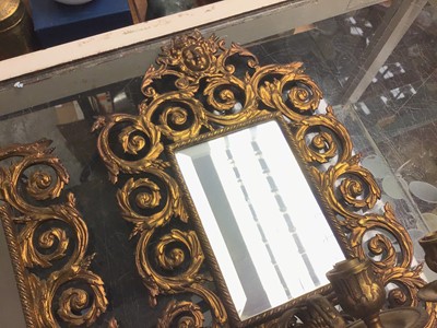 Lot 240 - Pair of heavy brass three-branch mirror candelabra, decorated with masks and scrollwork motif, 40 x 26cm