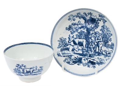 Lot 211 - A Liverpool tea bowl and saucer, printed in blue with a milkmaid, farmer, cattle and dog, circa 1780, probably Pennington and Part's Factory. Provenance: Williams-Wood Collection