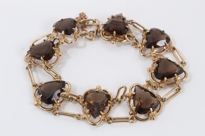 Lot 61 - 9ct gold smoky quartz bracelet with eight heart shaped smoky quartz, interspaced with long oval links