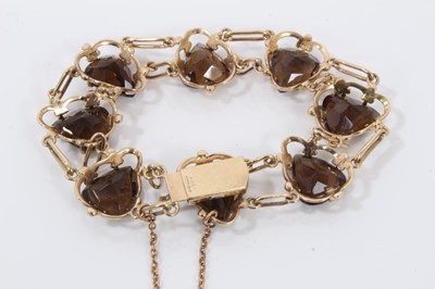 Lot 61 - 9ct gold smoky quartz bracelet with eight heart shaped smoky quartz, interspaced with long oval links