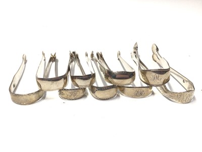 Lot 326 - Nine pairs of Georgian and Victorian silver sugar tongs, most with bright cut engraved decoration, various dates and makers, (9)