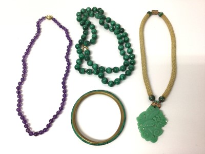 Lot 653 - Amethyst bead necklace with 14ct gold clasp, green glass pendant on rope necklace, malachite bead necklace and bangle