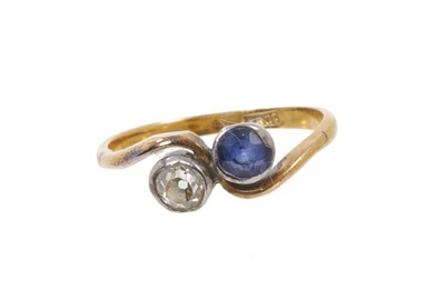 Lot 613 - Diamond and sapphire two-stone crossover ring