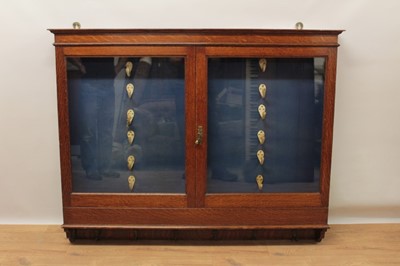 Lot 1275 - Early 20th century oak wall hanging gun cabinet