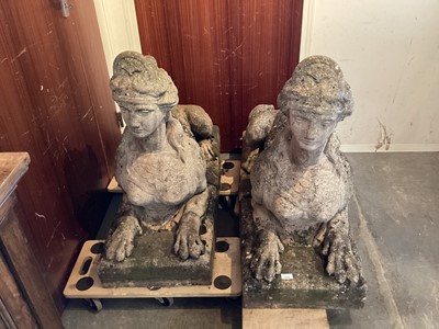 Lot 1284 - Impressive pair of concrete garden sculptures in the form of sphinxes, 107cm long