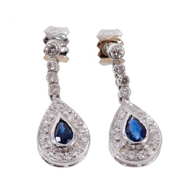 Lot 673 - Pair of sapphire and diamond cluster pendant earrings in 18ct white gold setting