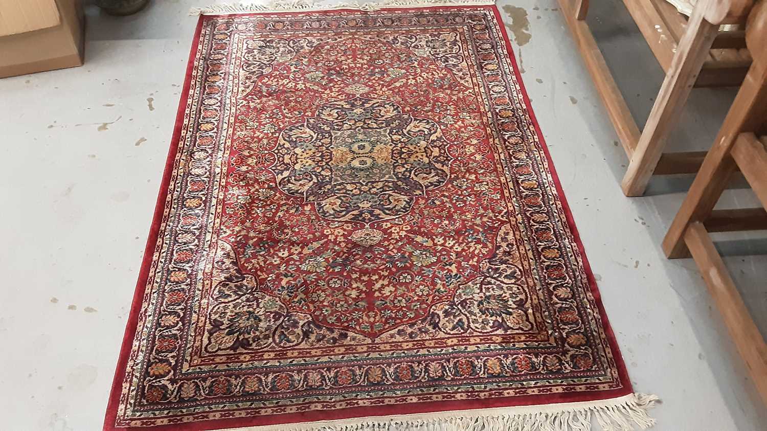 Lot 1020 - Old rug with floral decoration on red