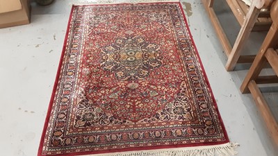 Lot 1020 - Old rug with floral decoration on red ground