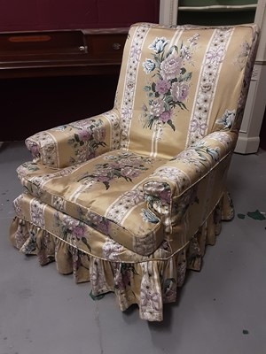 Lot 867 - Victorian armchair with loose floral cover on turned front legs and brass castors, 77cm wide, 85cm deep approximately, 95cm high