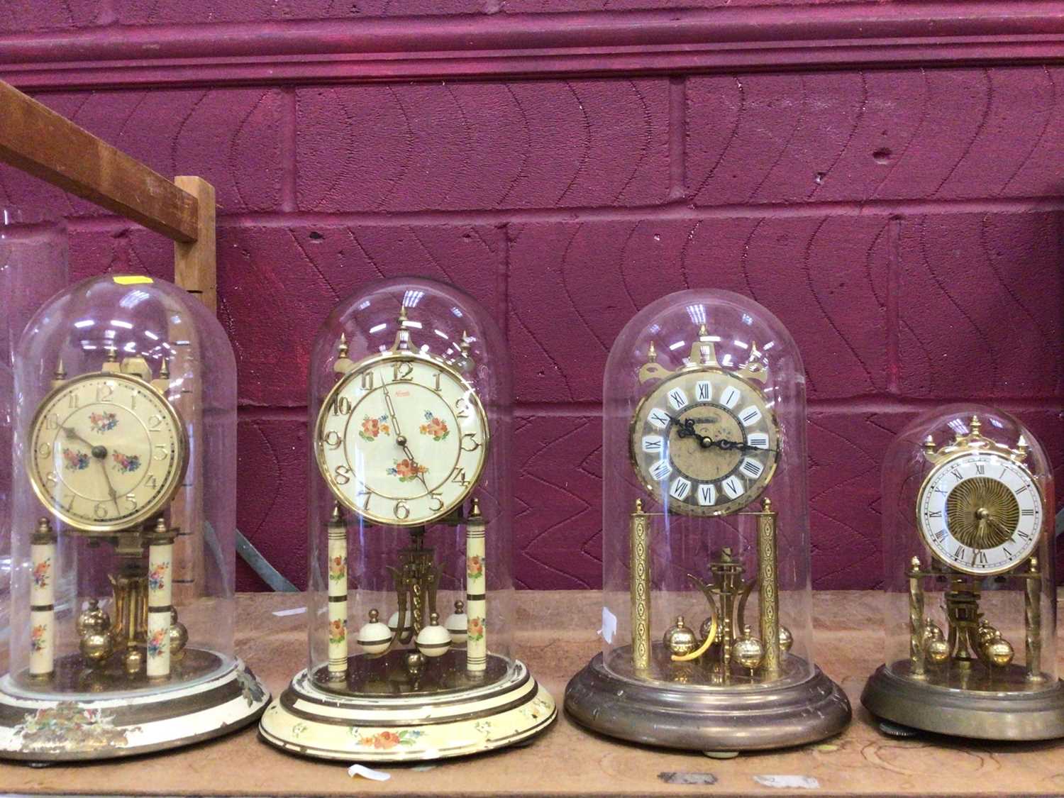 Lot 518 - Four glass domed clocks