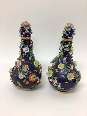Lot 199 - Pair of 19th century floral encrusted vases and covers