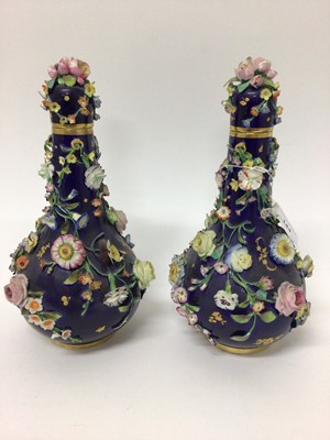 Lot 199 - Pair of 19th century floral encrusted vases and covers