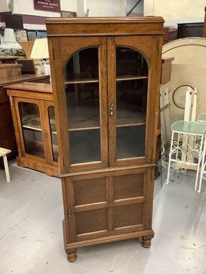 Lot 879 - Oak bookcase with shelved interior enclosed by two glazed doors with panelled door below, 62cm wide, 28cm deep, 155cm high