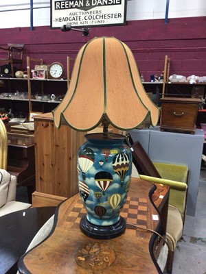Lot 366 - Ceramic table lamp and shade, painted with hot air balloons