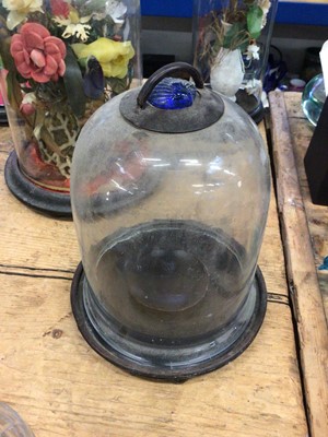 Lot 15 - Three antique glass domes (two with artificial flowers) together with two glass-domed lanterns with blue glass shell-form tops (5)