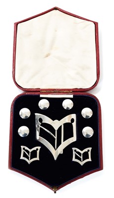 Lot 378 - Set of Edwardian silver buckles and buttons in fitted red leather box retailed by Vickey, Regent St.