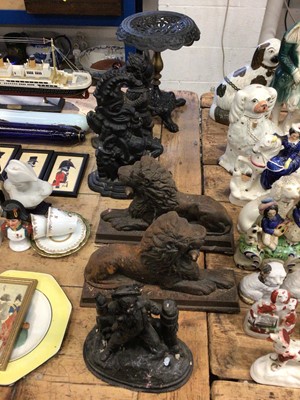 Lot 20 - Pair of cast iron lion doorstops, together with a pair of Punch and Judy doorstops, a cast iron stand with lions paw feet and a figurine (6)