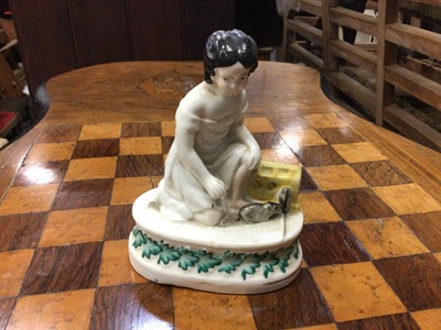 Lot 60 - Unusual Victorian Staffordshire figure of a girl with two rats or mice, the oval base decorated with a foliate pattern