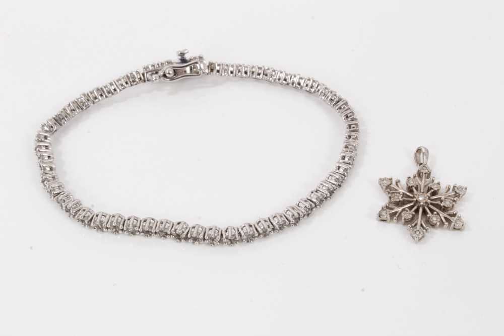 Lot 122 - Diamond tennis bracelet with clusters of diamonds in silver setting, together with a diamond snowflake pendant in silver setting