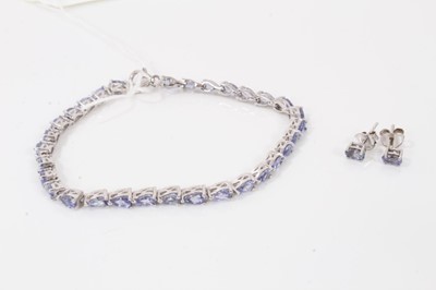 Lot 123 - Tanzanite bracelet with a continuous line of pear cut tanzanites in platinum overlaid silver setting together with a pair similar stud earrings