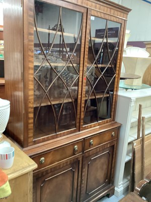 Lot 906 - Georgian style mahogany two height bookcase with adjustable shelves above enclosed by two astragal glazed doors, two drawers and two doors below, 115cm wide, 40cm deep, 206cm high