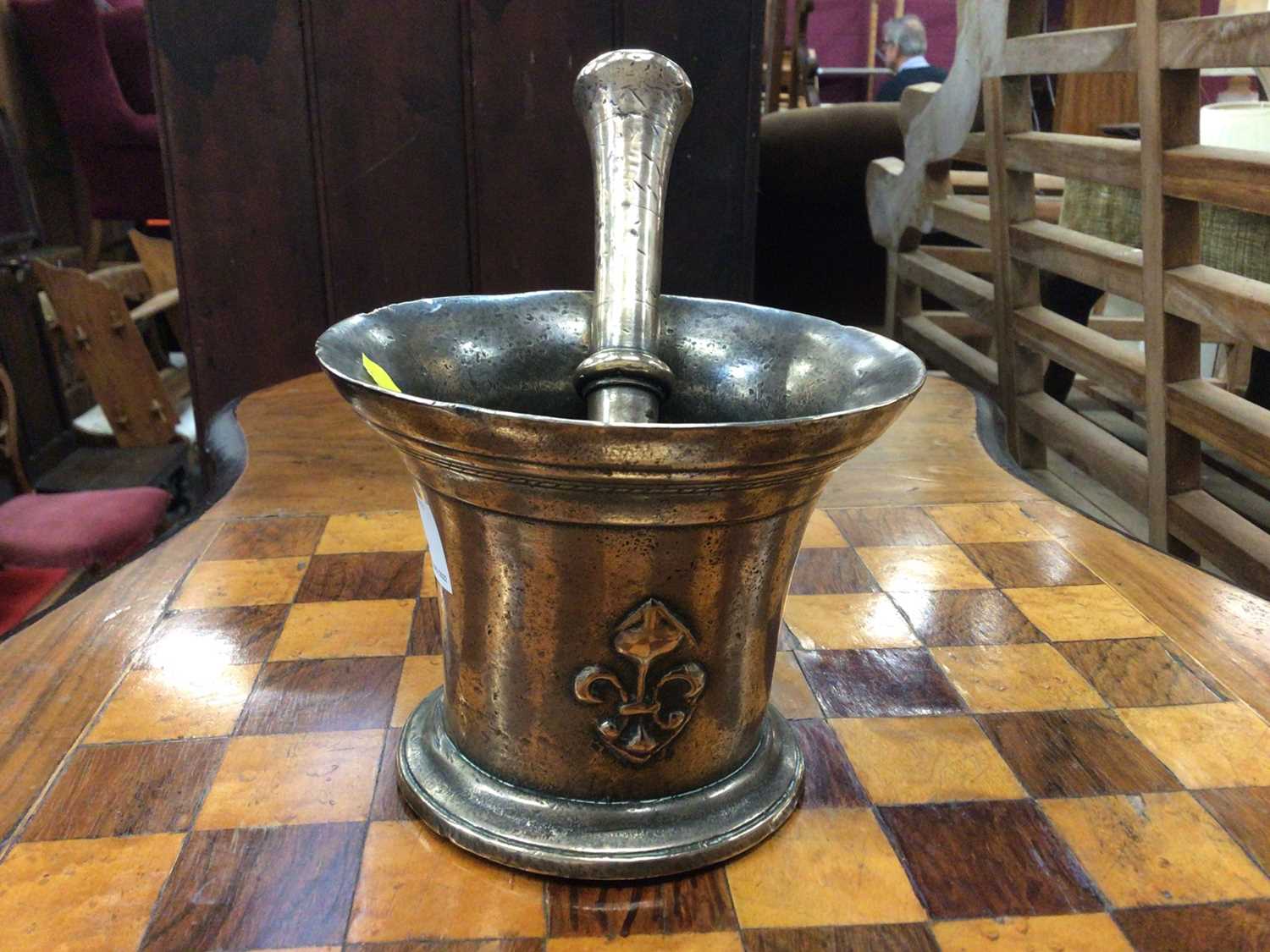 Lot 75 - Antique bell metal pestle and mortar, the mortar which a raised fleur-de-lys on each side, the pestle engraved 'AD'